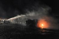 <p>Police use a water cannon to put out a fire started by protesters during a protest against plans to pass the Dakota Access pipeline near the Standing Rock Indian Reservation, near Cannon Ball, North Dakota, U.S. November 20, 2016. (Stephanie Keith/Reuters) </p>