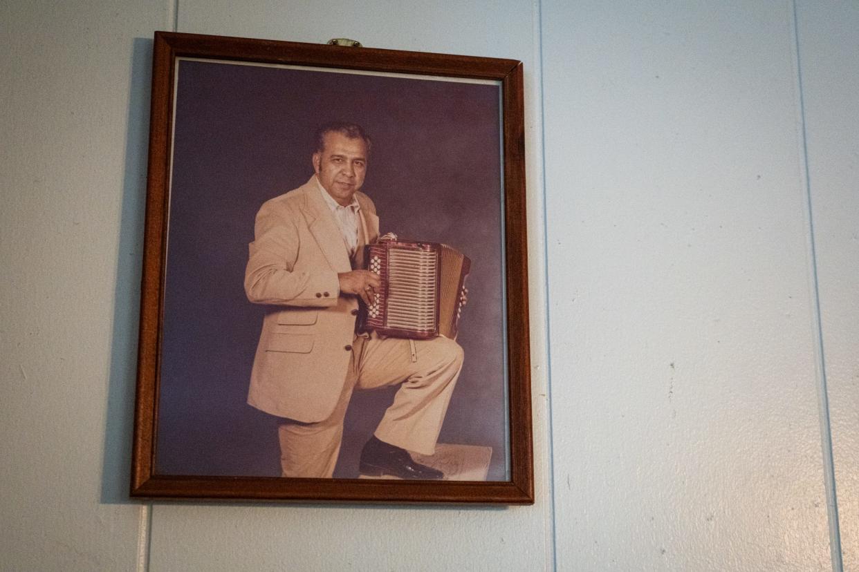 A photo of conjunto music legend and life-long Austinite Johnny Degollado with his accordion is displayed in his Montopolis home, April 30, 2024.