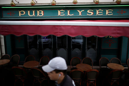 A man walks past the Pub Elysee in Sable-sur-Sarthe, western France, January 31, 2017. In Sable-sur Sarthe, a farming town of 13,000 where Francois Fillon, 2017 presidential candidate of the French centre-right, has been the dominant figure since launching himself on a 30-year career in public life which led to a five-year spell as prime minister, Fillon’s scandal over his wife’s work is on everyone's minds. Picture taken January 31, 2017. REUTERS/Stephane Mahe