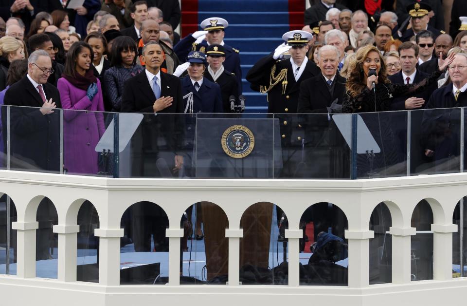 President Barack Obama, left and Vice President Joe Biden listen as singer Beyonce sings the National Anthem at the ceremonial swearing-in on the West Front of the U.S. Capitol during the 57th Presidential Inauguration in Washington, Monday, Jan. 21, 2013. (AP Photo/Scott Andrews, Pool)