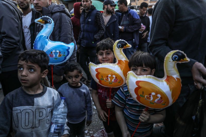 Street vendors sell dolls for children Monday in a popular market in preparation for the upcoming Muslim Eid al-Fitr celebrations, in the shadow of Israeli attacks in the Gaza Strip, in Rafah. Muslims around the world started celebrating the Eid al-Fitr holiday Tuesday nnight, which marks the end of the fasting month of Ramadan. Photo by Ismael Mohamad/UPI