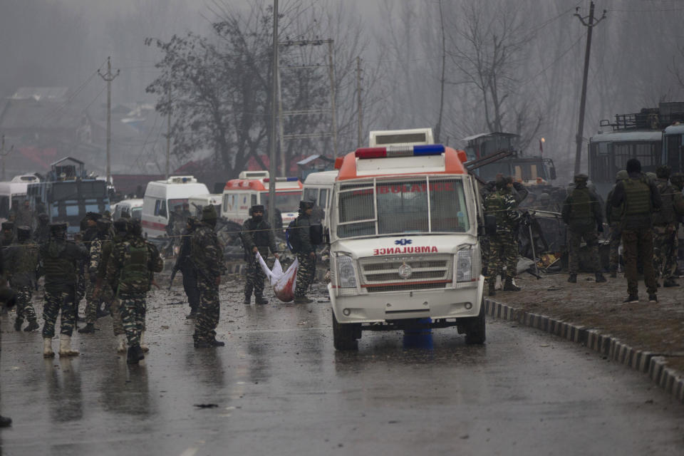 FILE - In this Thursday, Feb. 14, 2019 file photo, Indian paramilitary soldiers carry the remains of colleagues at the site of an explosion that killed at least 40 soldiers in Pampore, Indian-controlled Kashmir. With India’s national elections barely months away, Prime Minister Narendra Modi is under heavy pressure from his supporters to punish nuclear-rival Pakistan for a suicide attack on an Indian paramilitary convoy that killed at least 41 soldiers in disputed Kashmir. (AP Photo/Dar Yasin)