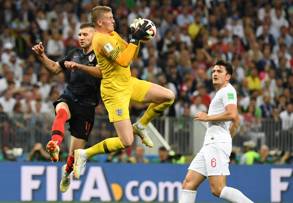 <p>England’s goalkeeper Jordan Pickford (C) stops a shot on goal by Croatia’s forward Ante Rebic (L) next to England’s defender Harry Maguire (R) during the Russia 2018 World Cup semi-final football match between Croatia and England at the Luzhniki Stadium in Moscow on July 11, 2018. (Photo by YURI CORTEZ / AFP) </p>