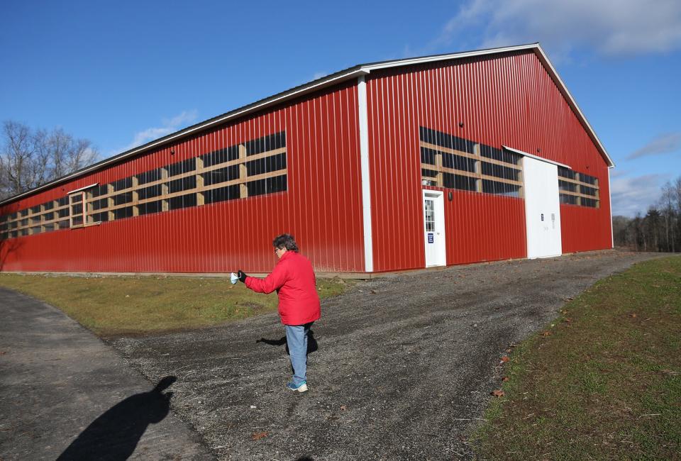 Lisa Dennison, executive director of the New Hampshire SPCA, walks through the new horse barn, which is part of the expansion project in Stratham, Friday, Dec. 3, 2021.