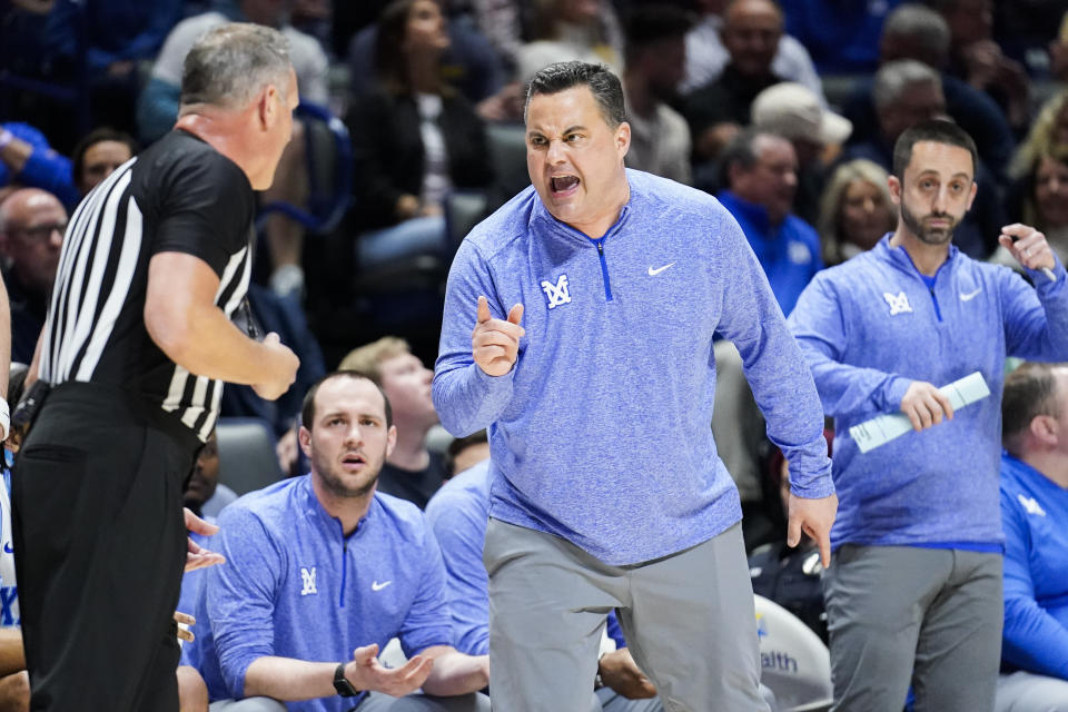 Xavier head coach Sean Miller, front right, argues with an official, left, during the first half of an NCAA college basketball game against Butler, Saturday, March 4, 2023, in Cincinnati. (AP Photo/Joshua A. Bickel)