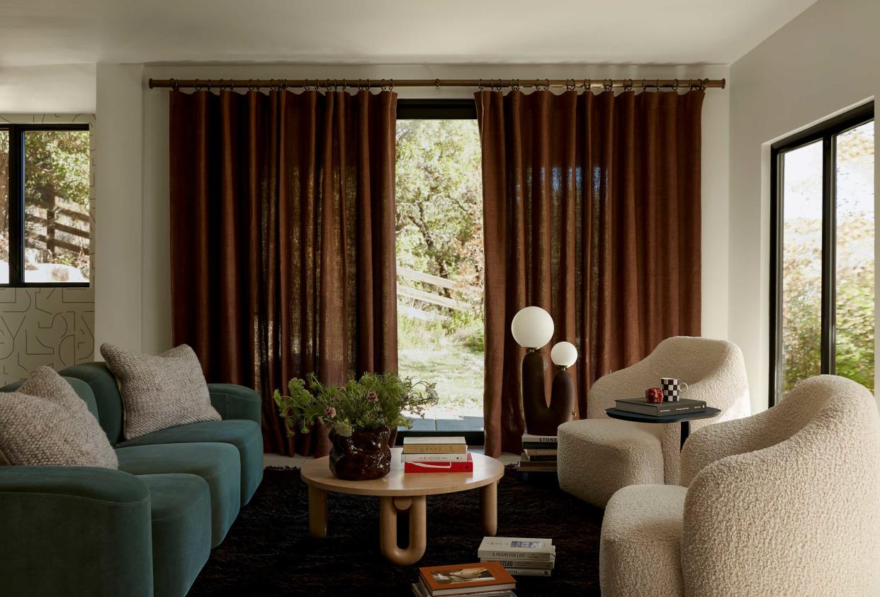  a living room with rust color curtains 