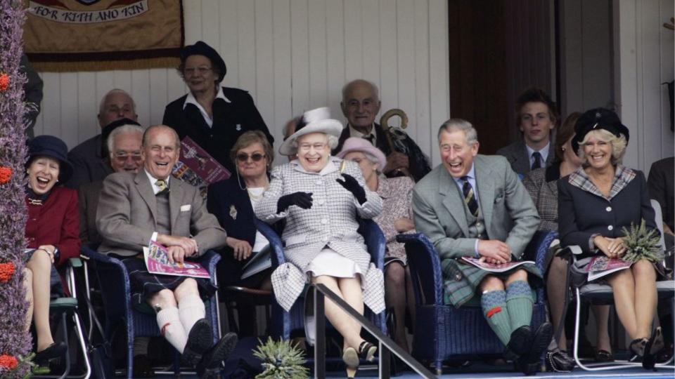 Prince Charles, Prince of Wales and Camilla, Duchess of Cornwall with Queen Elizabeth II and Prince Philip, Duke of Edinburgh laugh at their Balmoral team in the tug of war competition at the Braemar Games Highland gathering on September 2, 2006, Scotland