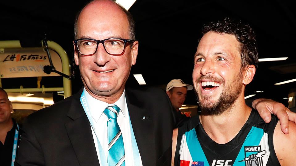 David Koch, pictured here with Port Adelaide captain Travis Boak after a game.