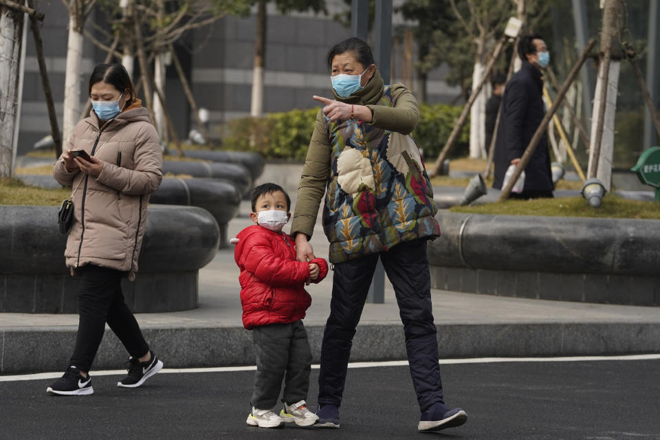 Residents wearing masks to help curb the spread of the coronavirus in Wuhan, China, on Tuesday, Jan. 26, 2021. The central Chinese city of Wuhan where the coronavirus was first detected has largely returned to normal but is on heightened alert against a resurgence as China battles outbreaks elsewhere in the country. (AP Photo/Ng Han Guan)