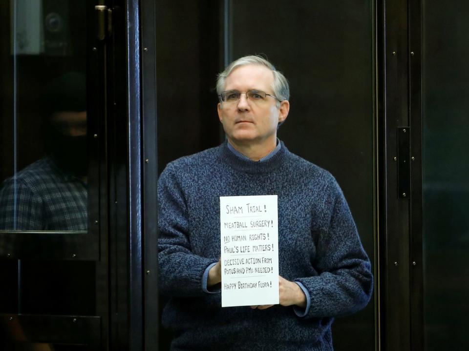 American detainee Paul Whelan holds a sign ahead of a hearing in Moscow.