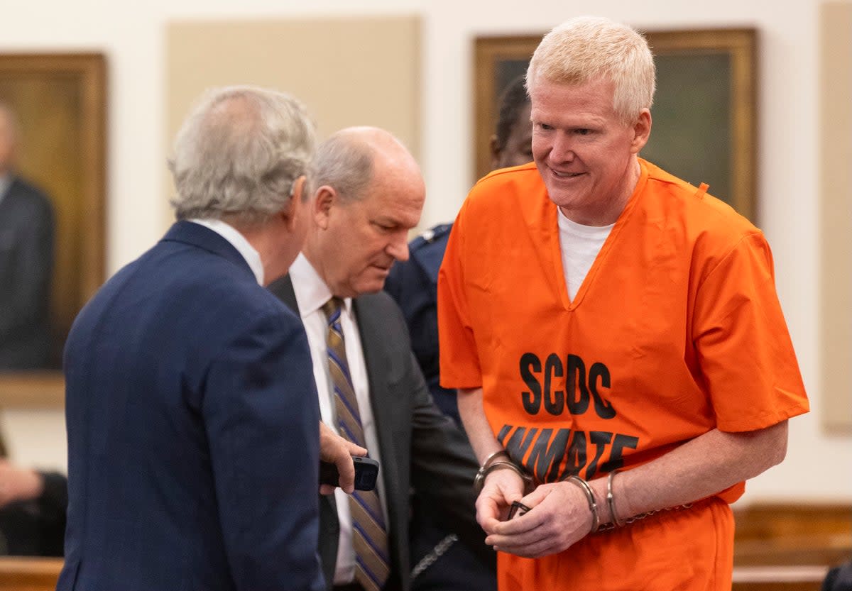 Alex Murdaugh smiles to his attorneys Dick Harpootlian, left, and Jim Griffin, right, as he arrives for his sentencing (AP)