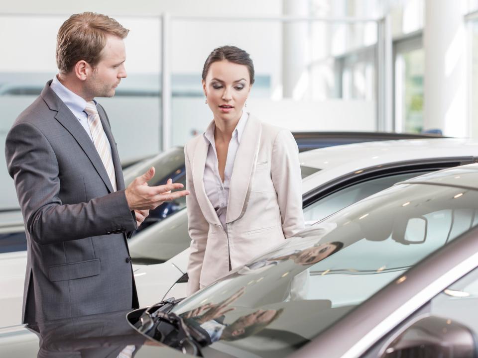 Woman talks to a man about buying a car after bankruptcy