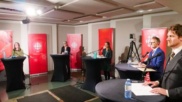 Yukon's federal candidates at CBC Yukon's election forum on Tuesday evening in Whitehorse: Lisa Vollans-Leduc (NDP), Barbara Dunlop (Conservative), Lenore Morris (Green), Brendan Hanley (Liberal) and Jonas Smith (Independent). (Claudiane Samson/CBC - image credit)