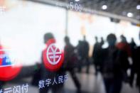 FILE PHOTO: A sign indicating digital yuan, also referred to as e-CNY, is pictured on a vending machine at a subway station in Shanghai, China