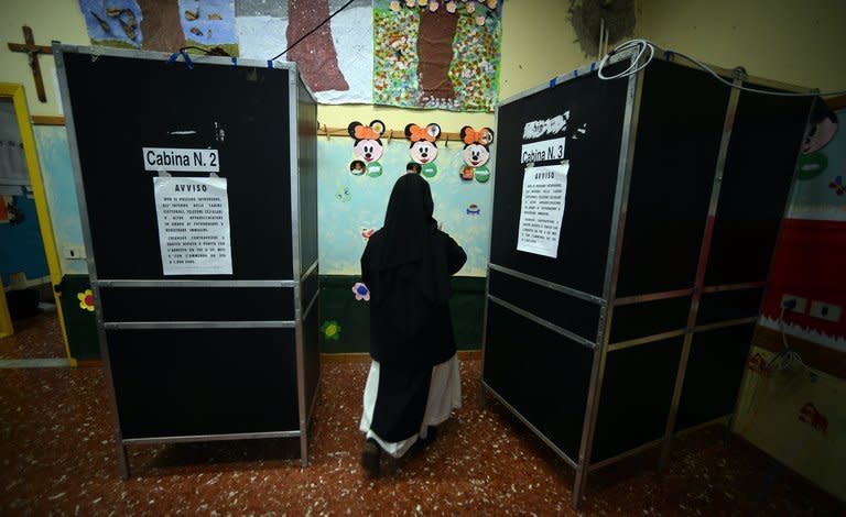 A nun gets ready to vote at a polling station in downtown Rome on February 24, 2013. Italy on Monday holds a second day of voting in a critical election for the future of the eurozone in which the centre-left Democratic Party is expected to win but fall short of a governing majority