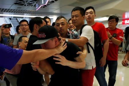 Pro-China demonstrators and anti-government protester scuffle at Amoy Plaza shopping mall in Kowloon Bay