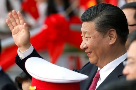 FILE PHOTO: China's President Xi Jinping waves after attending the inauguration ceremony of Chinese sponsored Vietnam-China Cultural Friendship Palace in Hanoi, Vietnam November 12, 2017. REUTERS/Kham/File Photo
