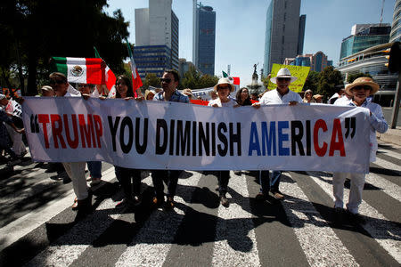 Demonstrators hold a banner during a march to protest against U.S. President Donald Trump's proposed border wall, and to call for unity, in Mexico City, Mexico, February 12, 2017. REUTERS/Jose Luis Gonzalez