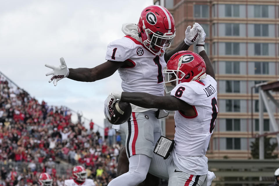 Georgia wide receivers Marcus Rosemy-Jacksaint (1) and Dominic Lovett (6) celebrate a touchdown against Vanderbilt in the first half of an NCAA college football game Saturday, Oct. 14, 2023, in Nashville, Tenn. (AP Photo/George Walker IV)