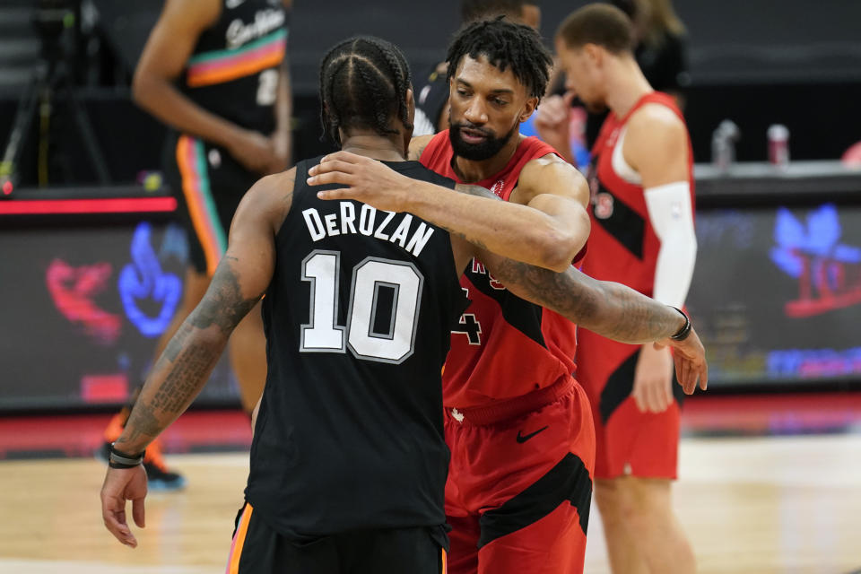 Toronto Raptors center Khem Birch congratulates San Antonio Spurs forward DeMar DeRozan (10) after an NBA basketball game Wednesday, April 14, 2021, in Tampa, Fla. (AP Photo/Chris O'Meara)