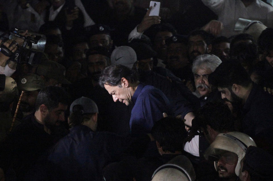 Khan, surrounded by supporters, leaves the district High Court in Lahore on Feb. 20.<span class="copyright">Mohsin Raza—Reuters</span>