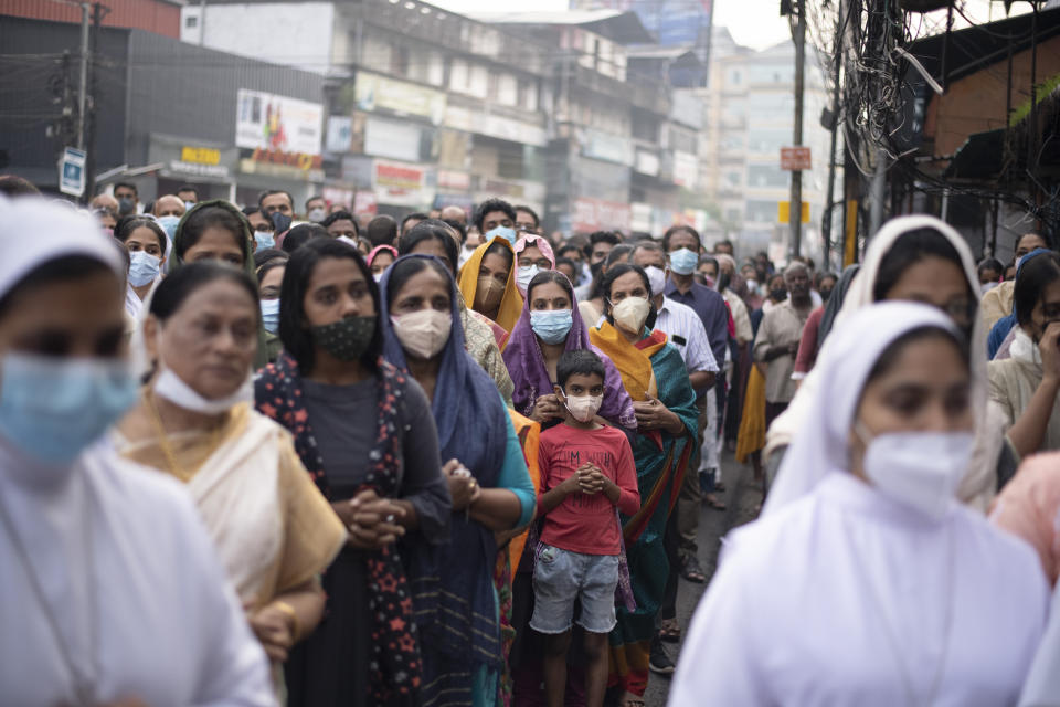 Indian Christians wearing masks as a precaution against COVID-19 gather for prayers as they observe Palm Sunday in Kochi, Kerala state, India, Sunday, April 10, 2022. The South Asian country has recorded a steep dip in coronavirus cases in recent weeks, with the health ministry reporting approximately 1,100 cases on Friday. (AP Photo/R S Iyer)