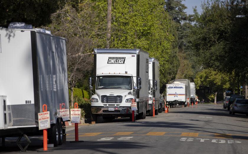 ALTADENA CA - APRIL 3, 2021: Cinema production trucks and trailers are parked along Woodbury Road for the filming of "Evolution of Nate Gibson" on April 3, 2021 in Altadena, California. On-location filming is returning to Hollywood post pandemic.(Gina Ferazzi / Los Angeles Times)
