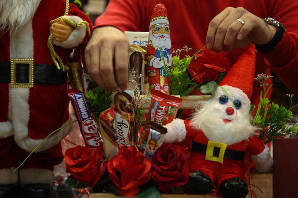 <span class="caption">Christmas is the classic example of the commercialisation of cultural tradition.</span> <span class="attribution"><a class="link " href="https://www.gettyimages.com.au/detail/news-photo/palestinian-seller-works-on-decorations-at-a-store-for-the-news-photo/1237065608?adppopup=true" rel="nofollow noopener" target="_blank" data-ylk="slk:Rizek Abdeljawad/Getty Images">Rizek Abdeljawad/Getty Images</a></span>
