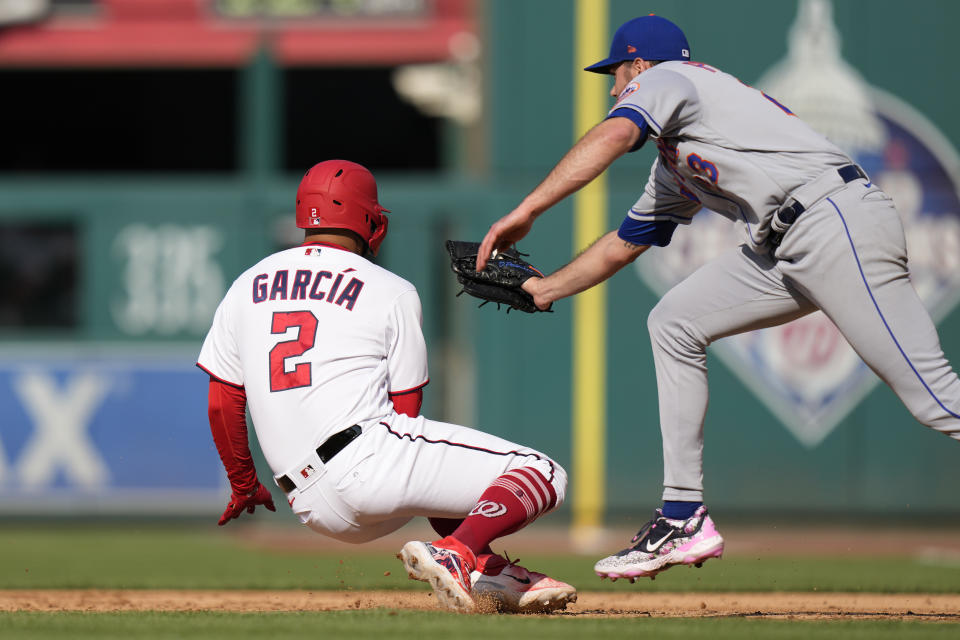 Washington Nationals' Luis Garcia (2) is tagged out by New York Mets starting pitcher David Peterson during a rundown between first and second bases during the fourth inning of a baseball game at Nationals Park, Monday, May 15, 2023, in Washington. (AP Photo/Alex Brandon)