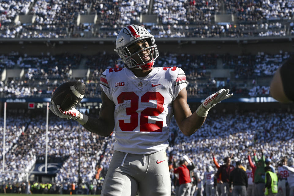 Ohio State running back TreVeyon Henderson (32) celebrates after scoring a touchdown against Penn State during the fourth quarter of an NCAA college football game, Saturday, Oct. 29, 2022, in State College, Pa. Ohio State won 44-31. (AP Photo/Barry Reeger)