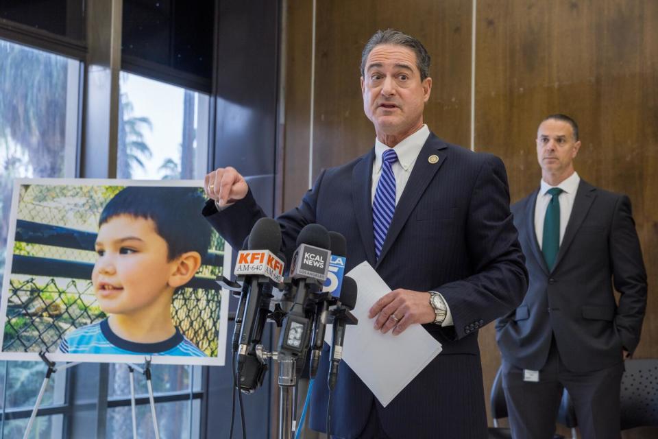 Todd Spitzer, center, Orange County district attorney, speaks about Aiden Leos accompanied by Deputy D.A. Dan Feldman