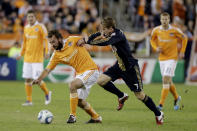 HOUSTON, TX - NOVEMBER 03: Adam Moffat #16 of the Houston Dynamo shields the ball from Brian Carroll #7 of the Philadelphia Union in the second leg of the playoffs on November 3, 2011 at Robertson Stadium in Houston, Texas. The Dynamo won 1 to 0 and will play the Sporting K.C. Sunday, November 6, 2011. (Photo by Thomas B. Shea/Getty Images)