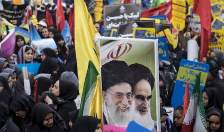 Students holding pictures of Iran's late leader Ayatollah Khomeini (R) and Iran's Supreme Leader Ayatollah Ali Khamenei, take part in an anti-USA demonstration outside the former U.S. embassy in Tehran in this November 4, 2015 file photo. REUTERS/Raheb Homavandi/TIMA/Files