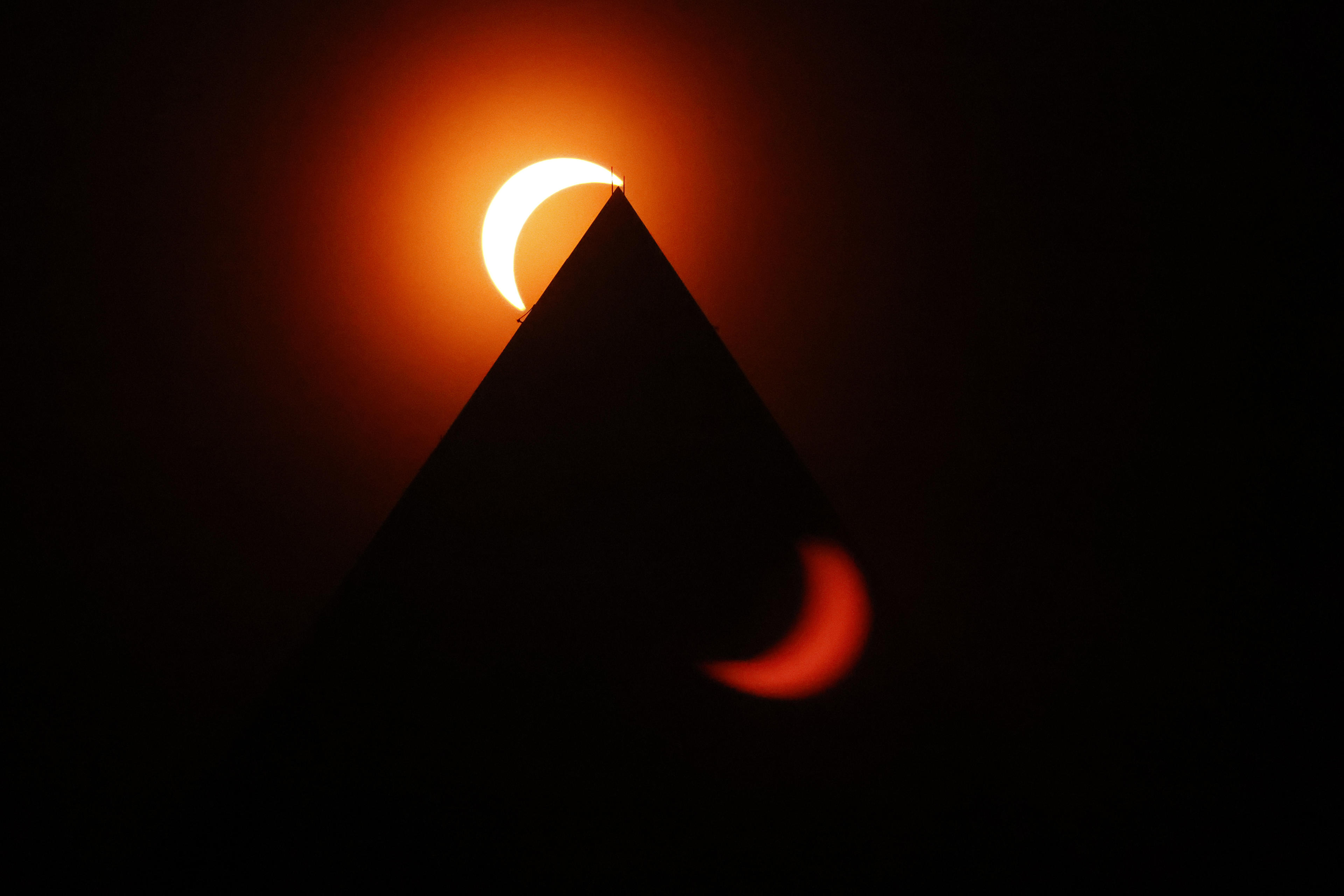 The solar eclipse is seen above the Washington Monument on April 08, 2024 in Washington, DC. (Chip Somodevilla/Getty Images)