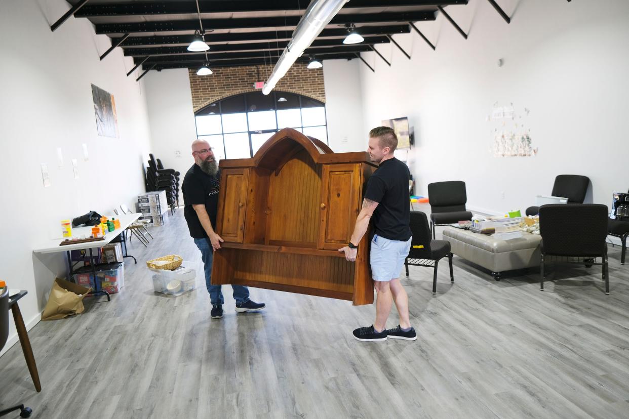 The Rev. Levi Duggan, founding pastor of the Ceili Community, works recently with Nick Bailey, the church's executive pastor, to move furniture around  a fellowship hall being converted into a community pantry.