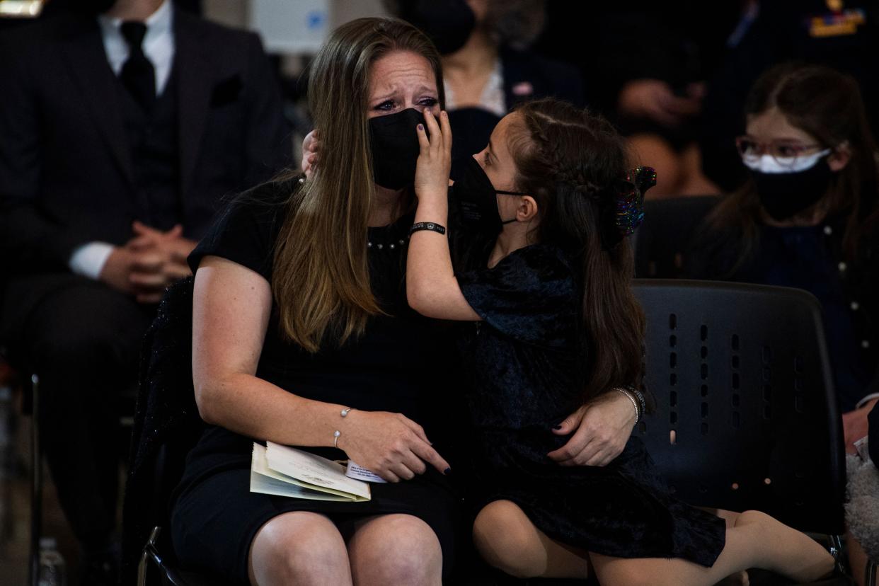 Abigail Evans, 7, the daughter of US Capitol Police Officer William "Billy" Evans, and her mother Shannon Terranova, pay respects as his remains lie in honor in the Capitol Rotunda in Washington, DC, on April 13, 2021.