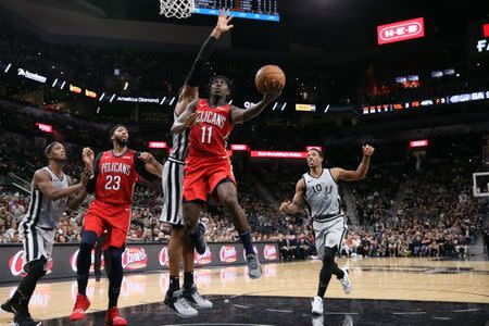 Nov 3, 2018; San Antonio, TX, USA; New Orleans Pelicans point guard Jrue Holiday (11) shoots the ball as San Antonio Spurs power forward LaMarcus Aldridge (behind) defends during the second half at AT&T Center. Soobum Im-USA TODAY Sports