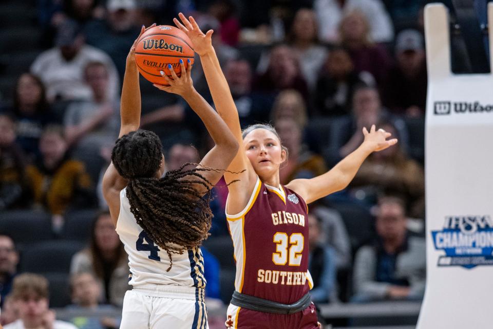 Gibson Southern High School freshman Paige Schnaus (32) attempts to block a shot by Norwell High School senior Dekota Hubble (4) during the second half of an IHSAA class 3A girls’ basketball state finals game, Saturday, Feb. 24, 2024, at Gainbridge Fieldhouse, in Indianapolis. Gibson Southern won, 63-60.