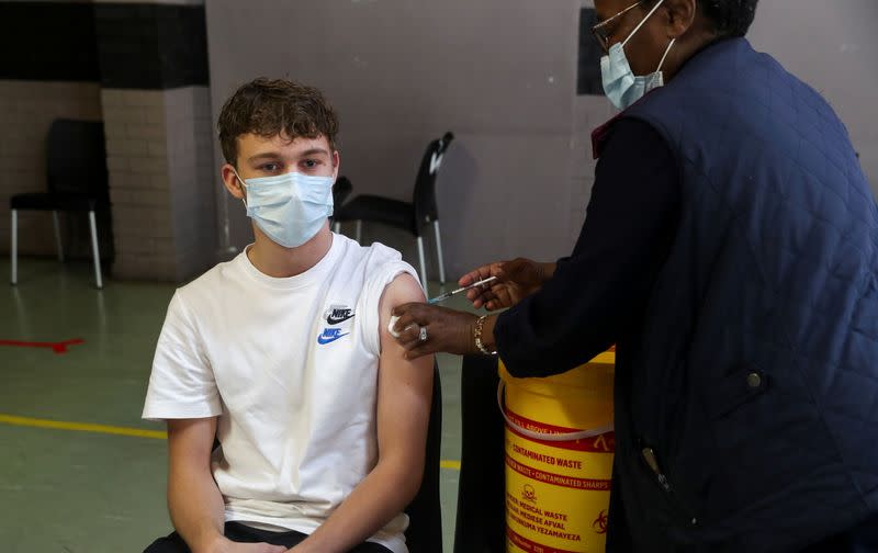 A healthcare worker administers a dose of the Pfizer coronavirus disease (COVID-19) vaccine to a teenager, amidst the spread of the SARS-CoV-2 variant Omicron, in Johannesburg