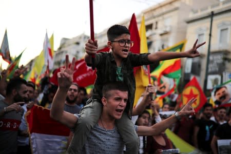 Kurds living in Greece shout slogans during a demonstration against Turkey's military action in northeastern Syria, in Athens