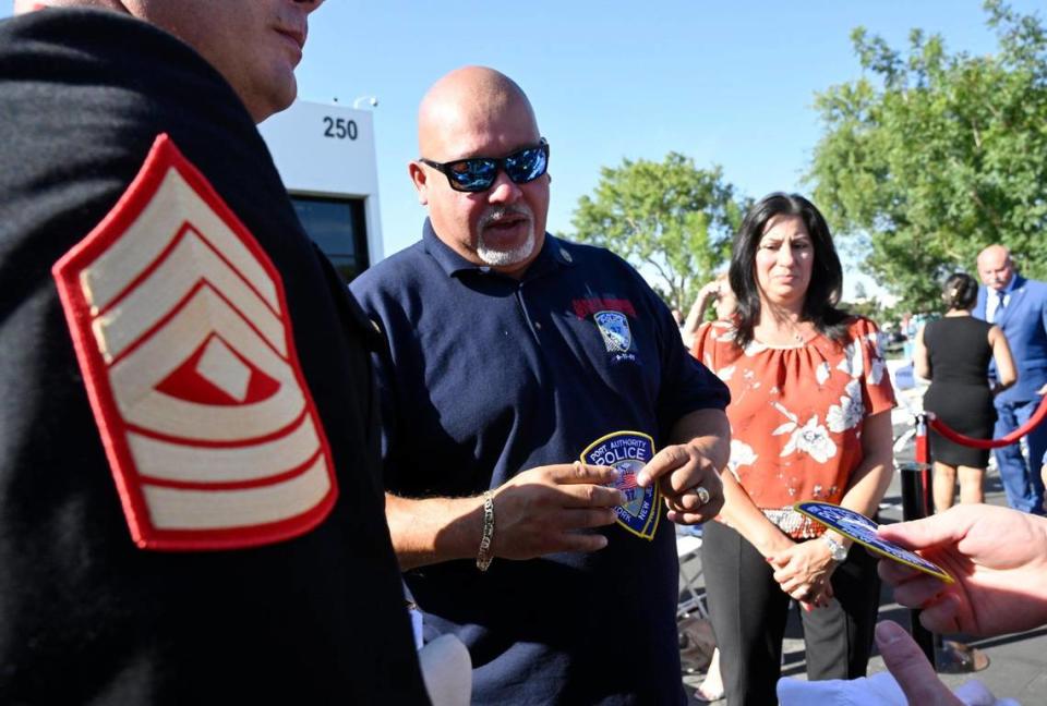 Retired Port Authority of New York and New Jersey Police Detective, World Trade Center attack survivor and guest speaker William Jimeno, center, hands out Port Authority patches as he is greeted by well-wishers following the annual 9/11 Memorial Ceremony Monday, Sept. 11, 2023 in Clovis.