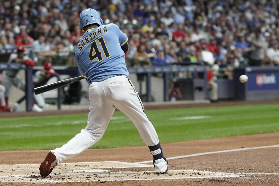 Milwaukee Brewers' Carlos Santana hits a single during the first inning of a baseball game against the Philadelphia Phillies Friday, Sept. 1, 2023, in Milwaukee. (AP Photo/Morry Gash)