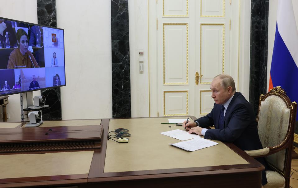 Russian President Vladimir Putin listens to Marina Akhmedova, on the tv screen, while attending the annual meeting of the Presidential Council for Civil Society and Human Rights via videoconference in Moscow, Russia, Wednesday, Dec. 7, 2022. (Mikhail Metzel, Sputnik, Kremlin Pool Photo via AP)