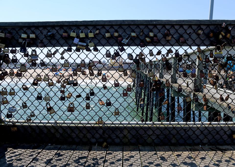 Locks still attached to the fishing pier fencing Monday, June 17, 2024, in Ocean City, Maryland.