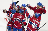 Montreal Canadiens' Cole Caufield (22) is congratulated by teammates after his winning goal over the Columbus Blue Jackets during overtime NHL hockey game action in Montreal, Thursday, Oct. 26, 2023. (Christinne Muschi/The Canadian Press via AP)