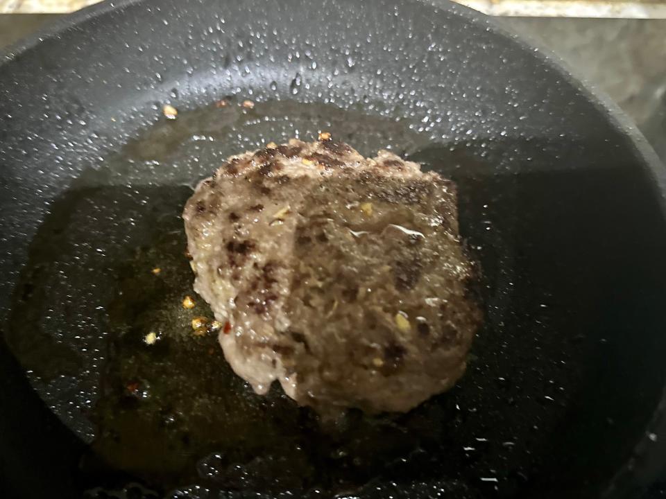 cooked burger patty in a pan on the stove