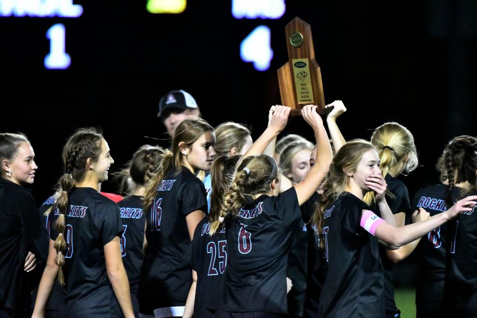 Assumption players hold the trophy following their 4-1 victory over Manual  in the championship game of the 7th Region girls soccer tournament, Saturday, Oct. 15, 2022 in Louisville Ky.