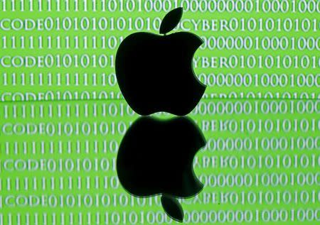A 3D printed Apple logo is seen in front of a displayed cyber code in this illustration taken February 26, 2016. Apple Inc's stance on privacy in the face of a U.S. government demand to unlock an iPhone belonging to one of the San Bernardino attackers has raised awkward questions for the world's mobile network operators. REUTERS/Dado Ruvic/Illustration
