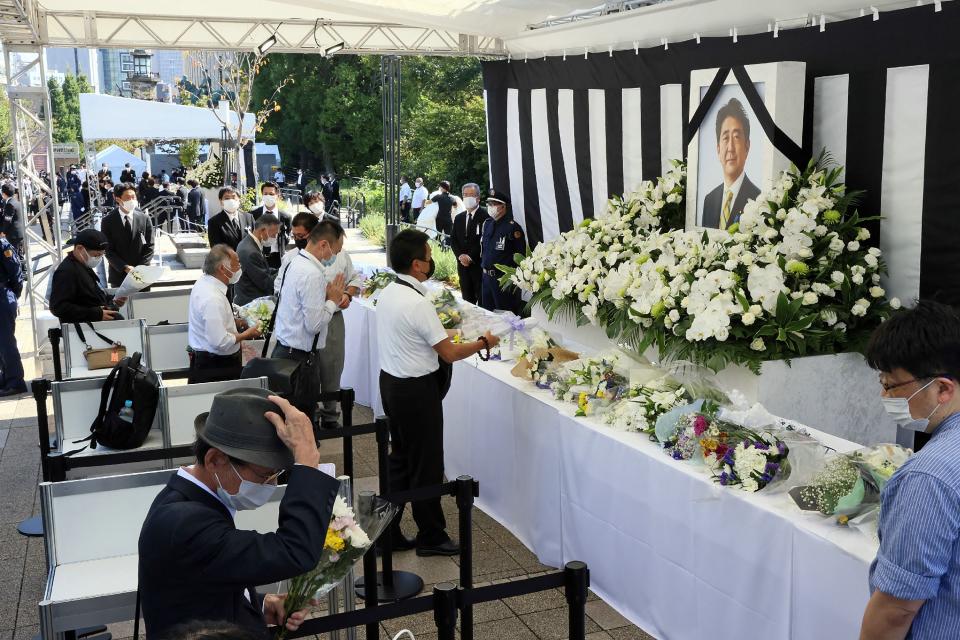 People leave flowers and pay their respects to former Japanese prime minister Shinzo Abe (JIJI PRESS/AFP via Getty Images)