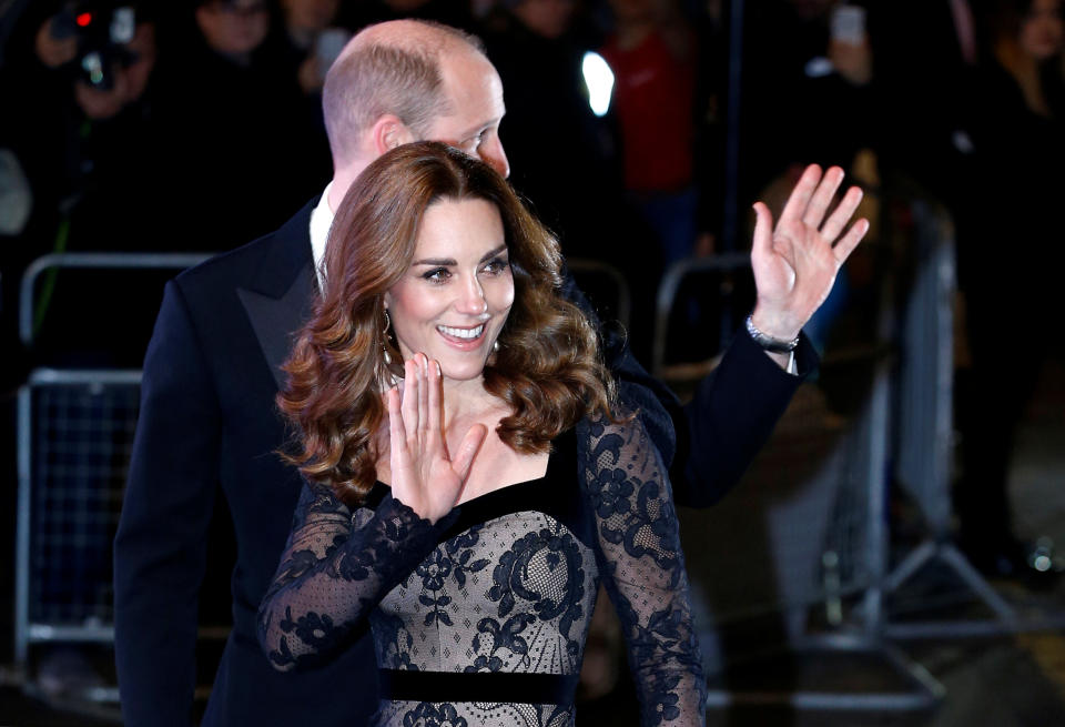 The royals are pictured waving to the crowds as they walked into the theater. (Photo: Henry Nicholls/Reuters)